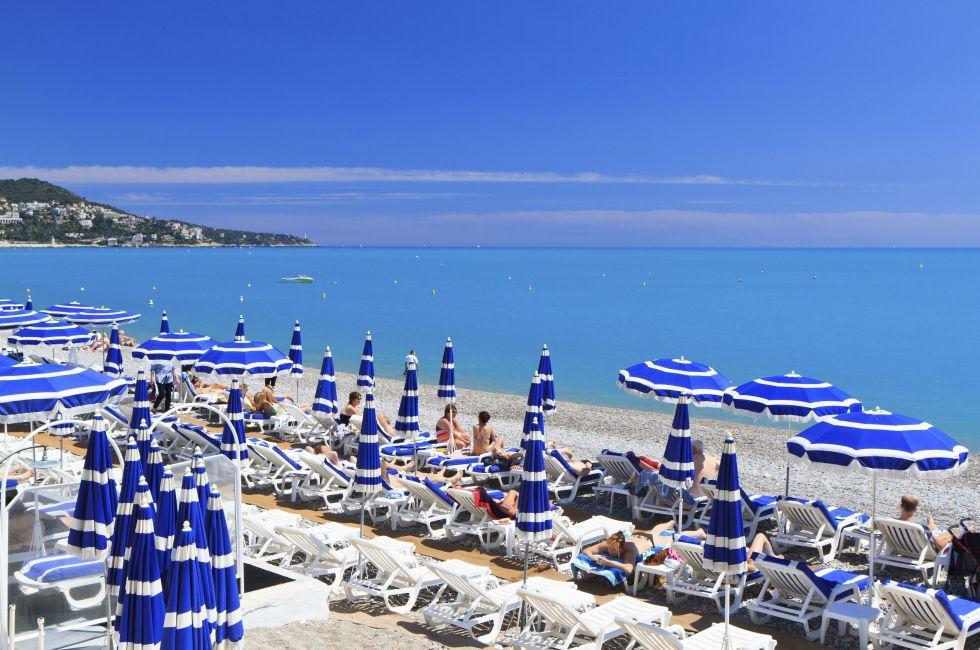 NICE, FRANCE - MAY 22: Sunbathers on the beach on May 22, 2013 in Nice. Nice has about 30 beaches which extend for more than 4 miles.; 