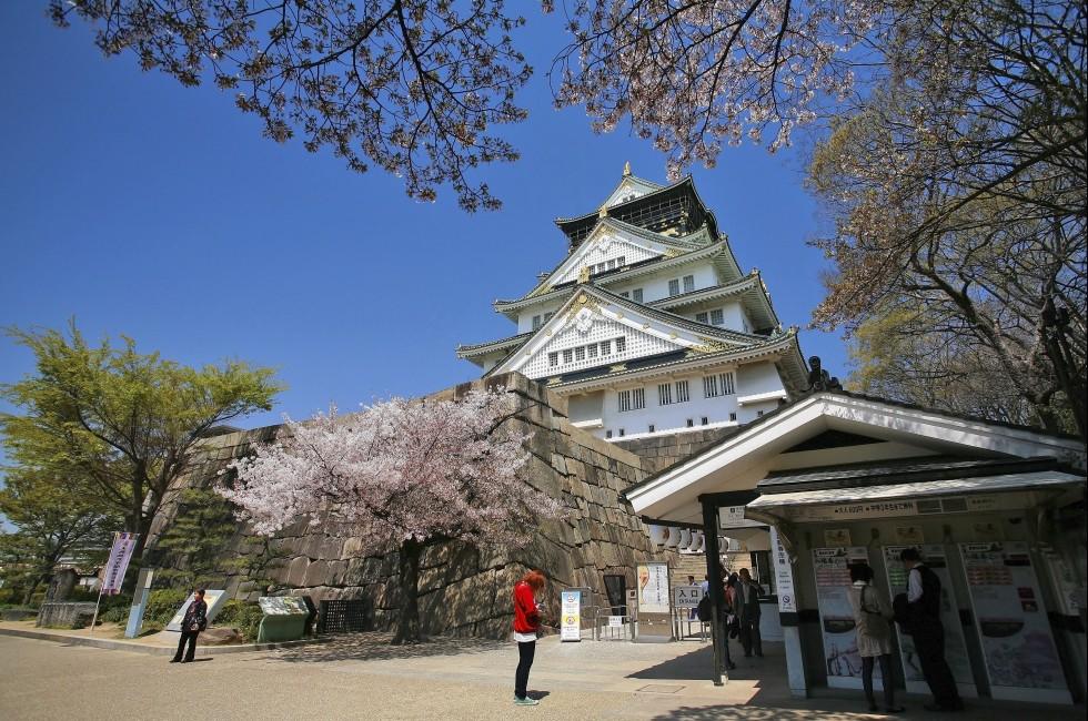 OSAKA-APR 13: Main entrance with cherry blossom of Osaka castle on April 13, 2011 in Osaka, Japan. This castle, founded in 1583, is covered by secondary citadels, gates, turrets, stone walls and moat.
