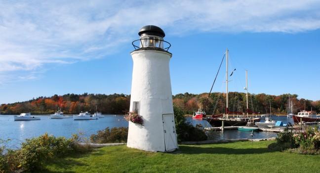 A Small Decorative Lighthouse And Boats In Harbor At Kennebunkport, Maine, USA, Panoramic View.