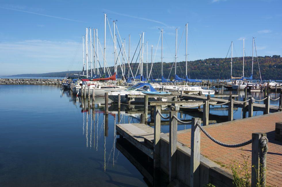 Sail boats at the boat marina at the southern end of Seneca lake in Watkins Glen New York on a beautiful blue sky day in autumn.