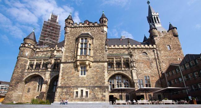 Aachen, Germany - August 28, 2013: The historical town hall (Rathaus) with people sitting in an outdoor cafe in Aachen, Germany on August 28, 2013.