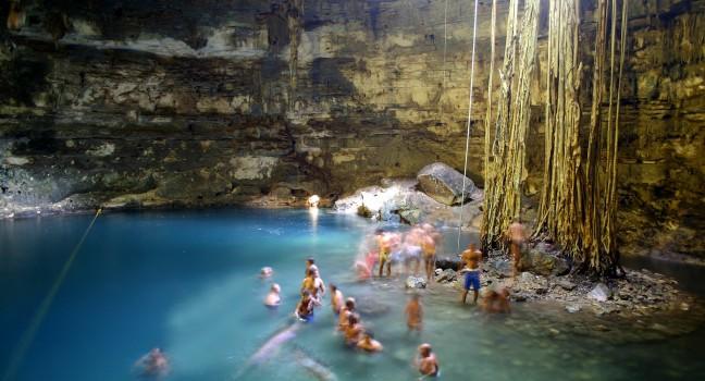 People bathing in limestone cave lake in Yucatan, Mexico.