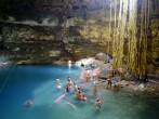 People bathing in limestone cave lake in Yucatan, Mexico.