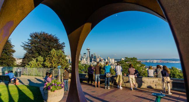 Seattle tourists at famous Kerry Park taking pictures at dusk.