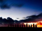 Silhouettes of fifteen moais against starry blue sky in Easter Island, Chile