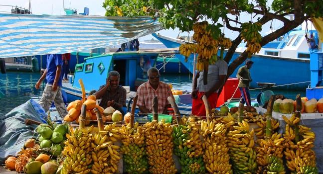 MALE - JULY 1: Three street vendors sit by bananas stall - Market situated on the harbor of Male - capital of Maldives - July 1, 2009 - Male - Maldives.; Shutterstock ID 43818457; Project/Title: Silversea; Downloader: Fodor's Travel