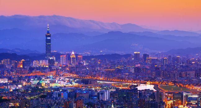 Taipei, Taiwan famed cityscape with mountains in the background.;