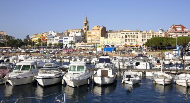 Port and touristic village of Palamos, Costa Brava (Catalonia, Spain). Many fishing boats moored.