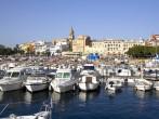 Port and touristic village of Palamos, Costa Brava (Catalonia, Spain). Many fishing boats moored.