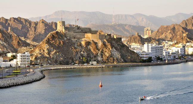 Hilltop fort on rocky outcrop overlooking the Muttrah Corniche and harbour in Muscat Oman;